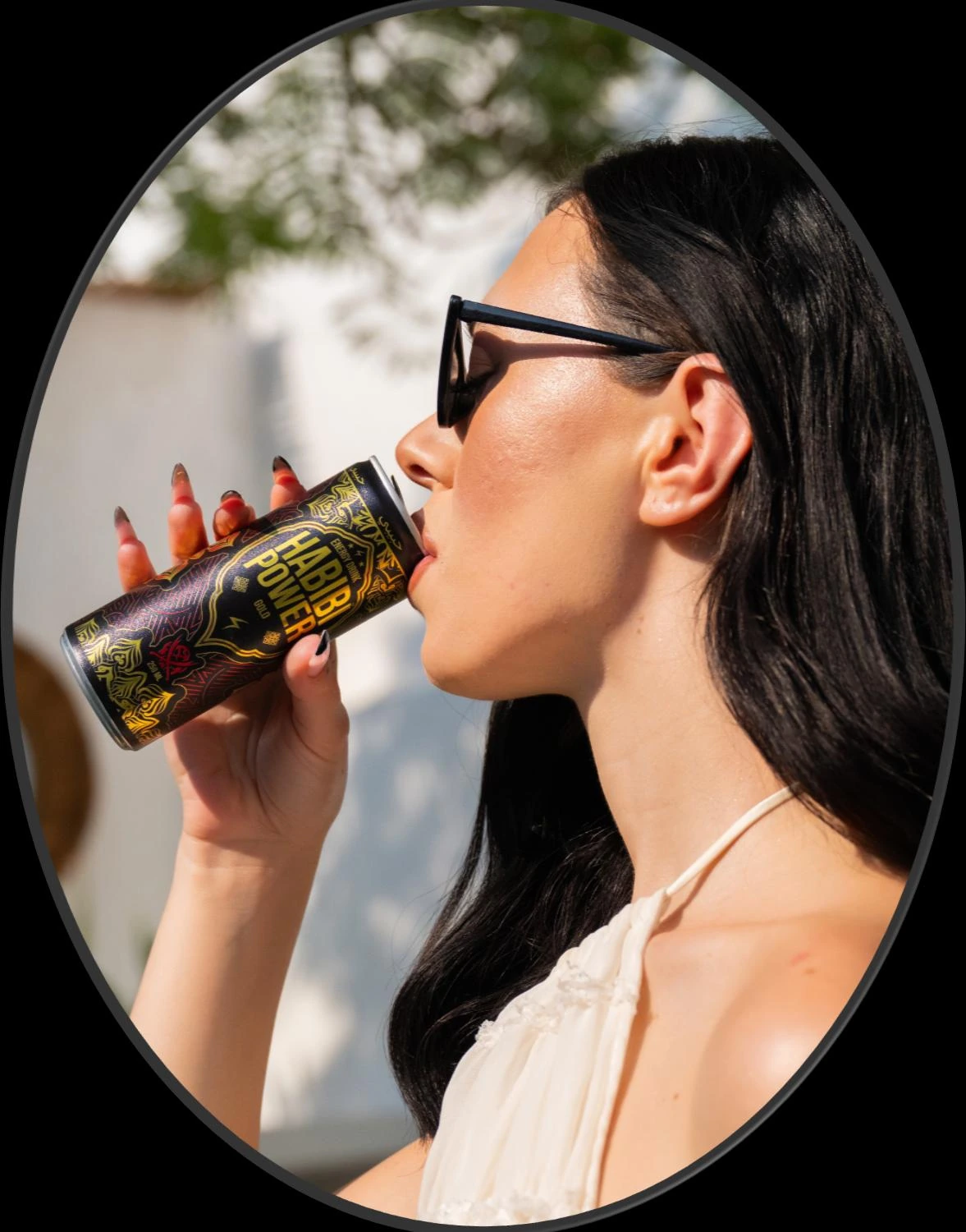 Woman enjoying a Habibi Power Gold Original energy drink
